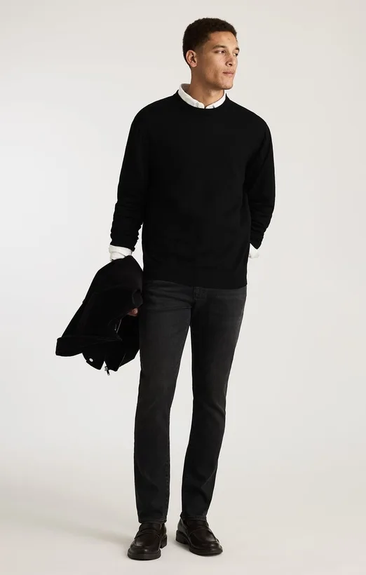 Black sweater over a collared shirt